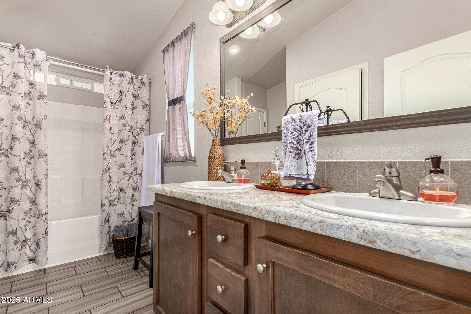 20514 West Narramore Road Buckeye, AZ 85326 - Photo 17 of 31 a bathroom with a granite countertop sink a toilet and shower curtain