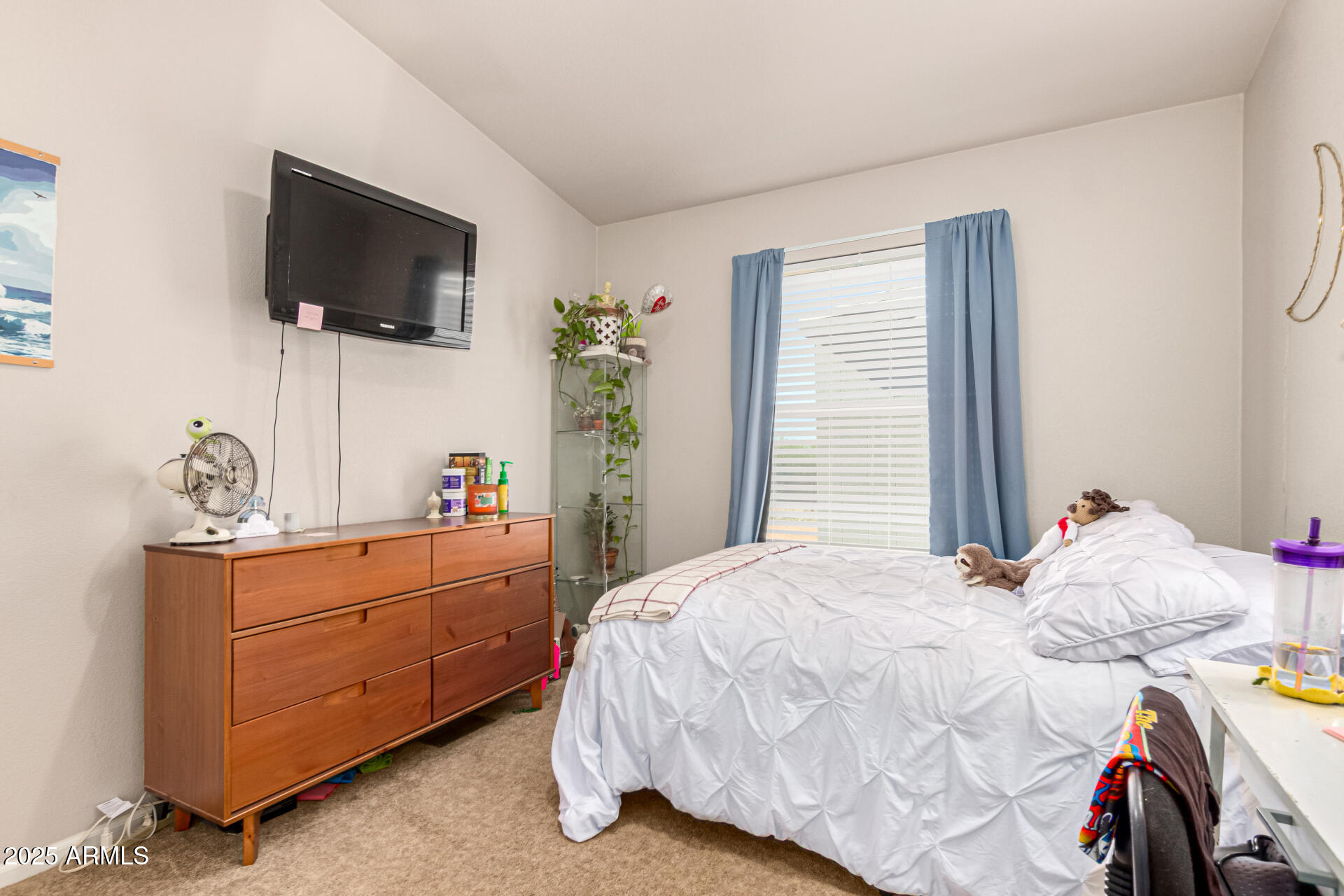 20514 West Narramore Road Buckeye, AZ 85326 - Photo 22 of 31 a bedroom with a bed and a flat tv screen on the dresser