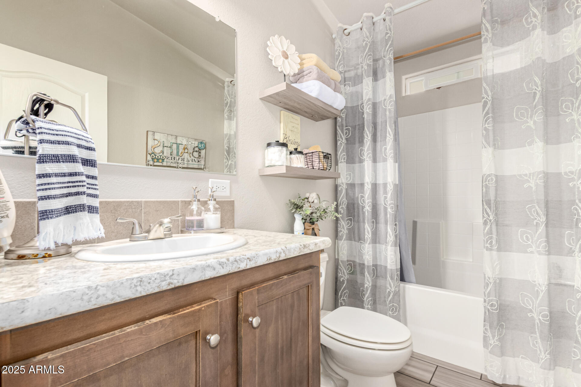 20514 West Narramore Road Buckeye, AZ 85326 - Photo 23 of 31 a bathroom with a granite countertop sink mirror vanity and toilet