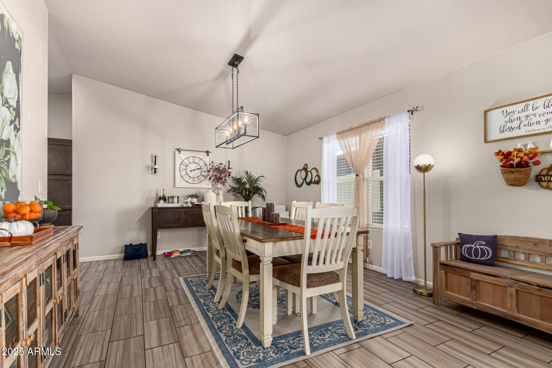 20514 West Narramore Road Buckeye, AZ 85326 - Photo 10 of 31 a view of a dining room with furniture and wooden floor