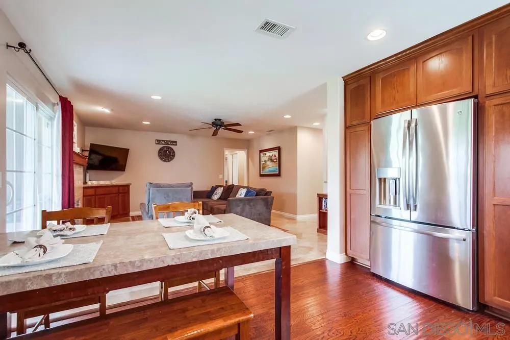 14020 Frame Road Poway, CA 92064 - Photo 11 of 52 a kitchen with stainless steel appliances granite countertop a refrigerator a sink and a stove with wooden floor