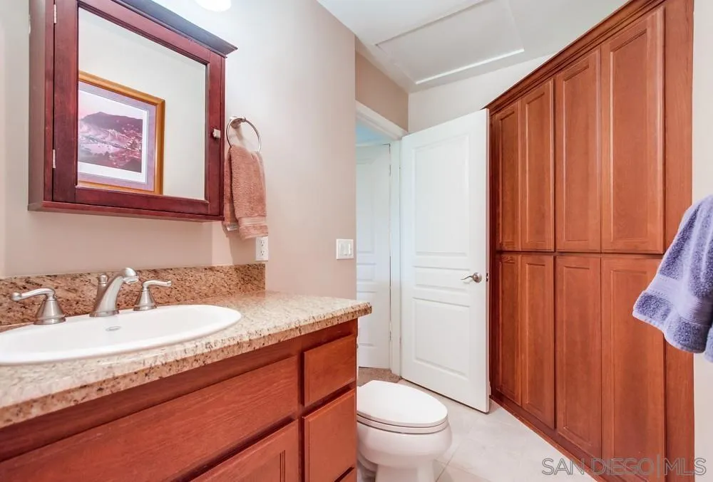 14020 Frame Road Poway, CA 92064 - Photo 19 of 52 a bathroom with a granite countertop sink toilet and shower