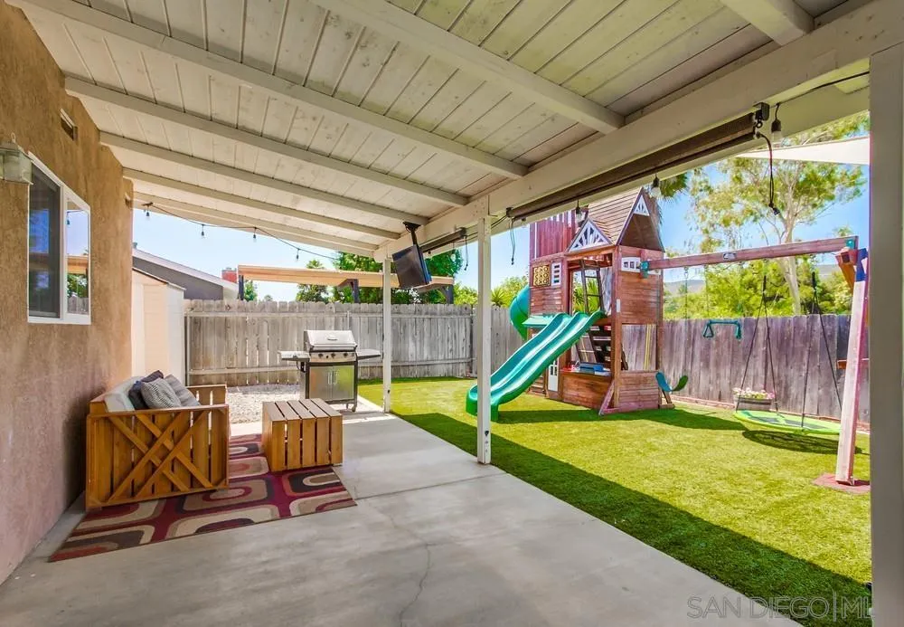 14020 Frame Road Poway, CA 92064 - Photo 49 of 52 a view of a backyard with a slide and a table and chairs