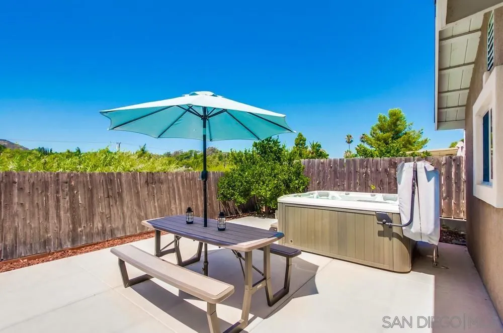 14020 Frame Road Poway, CA 92064 - Photo 52 of 52 a view of a patio with a table and chairs under an umbrella