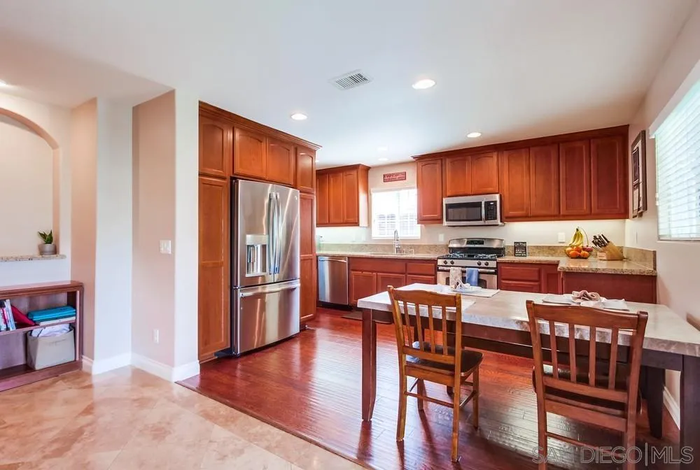 14020 Frame Road Poway, CA 92064 - Photo 8 of 52 a kitchen with stainless steel appliances granite countertop a refrigerator and a stove top oven