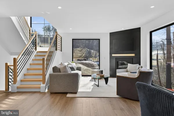 a living room with furniture and kitchen view