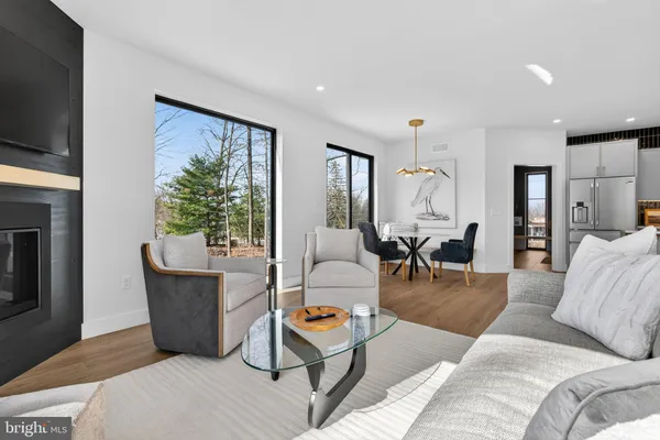 a living room with furniture and floor to ceiling windows