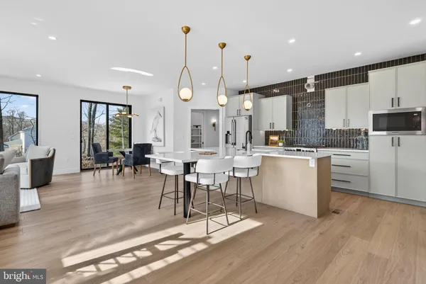 a kitchen with a dining table chairs sink and cabinets