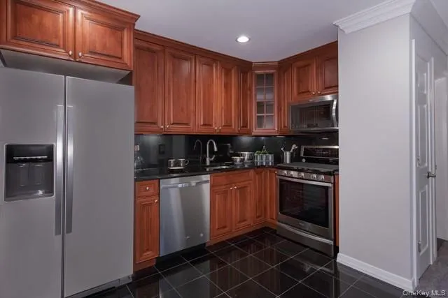 a kitchen with stainless steel appliances granite countertop a refrigerator and a stove top oven