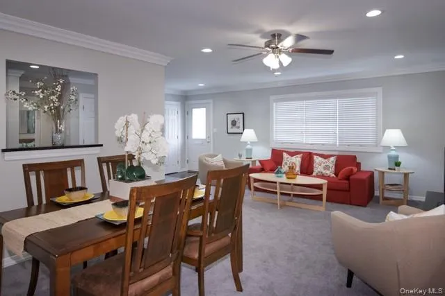 a living room with furniture and chandelier