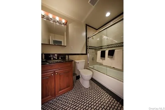 a bathroom with a sink a toilet and mirror