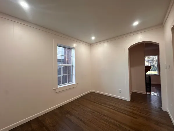an empty room with wooden floor