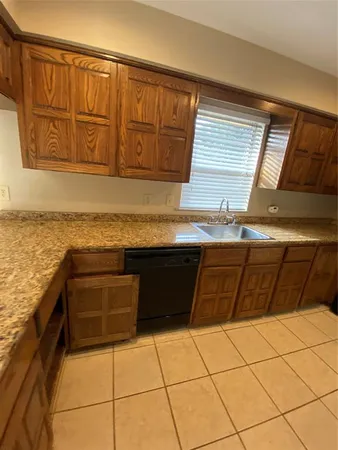 a kitchen with stainless steel appliances granite countertop a sink and cabinets