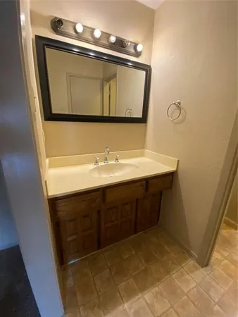 a bathroom with a sink vanity and mirror