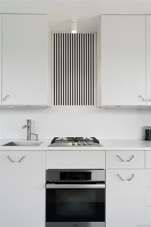 a kitchen with a sink stove and cabinets