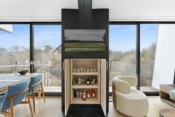 a balcony with chairs and a table