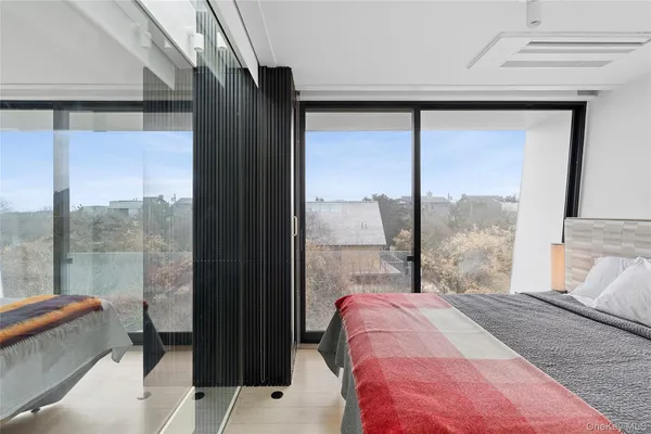a bedroom with a bed and a large window