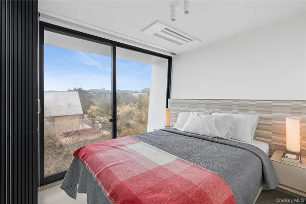 a bedroom with a large bed and a large window