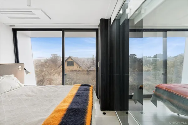 a bedroom with a large window and a bed