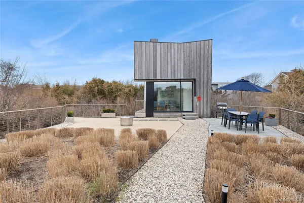 a view of a swimming pool with a patio and a yard