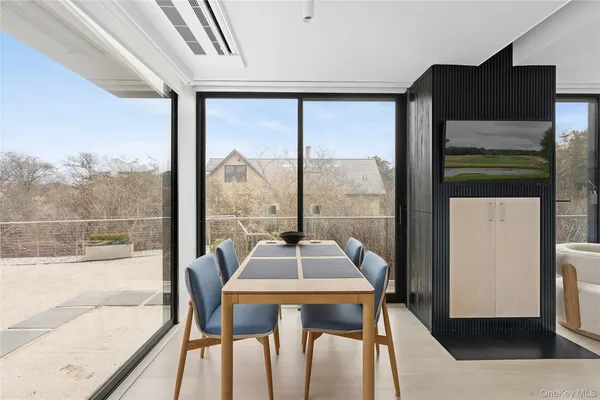 a view of a room with a large window and furniture