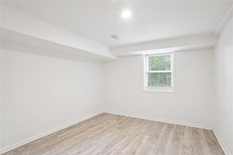 2533 Kelly Lake Road Decatur, GA 30032 - Photo 6 of 14 an empty room with wooden floor and windows