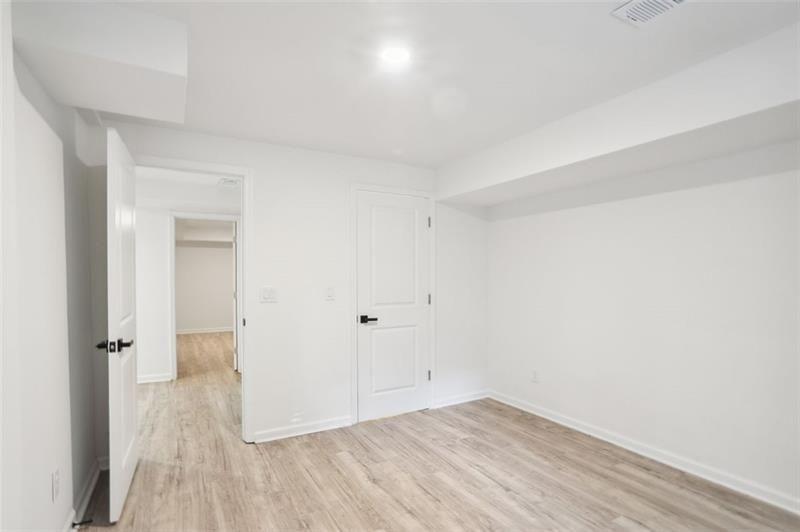 2533 Kelly Lake Road Decatur, GA 30032 - Photo 7 of 14 an empty room with wooden floor and windows