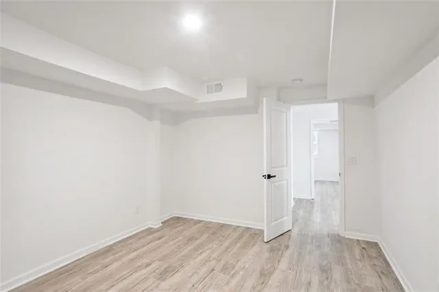 a view of a room with wooden floor
