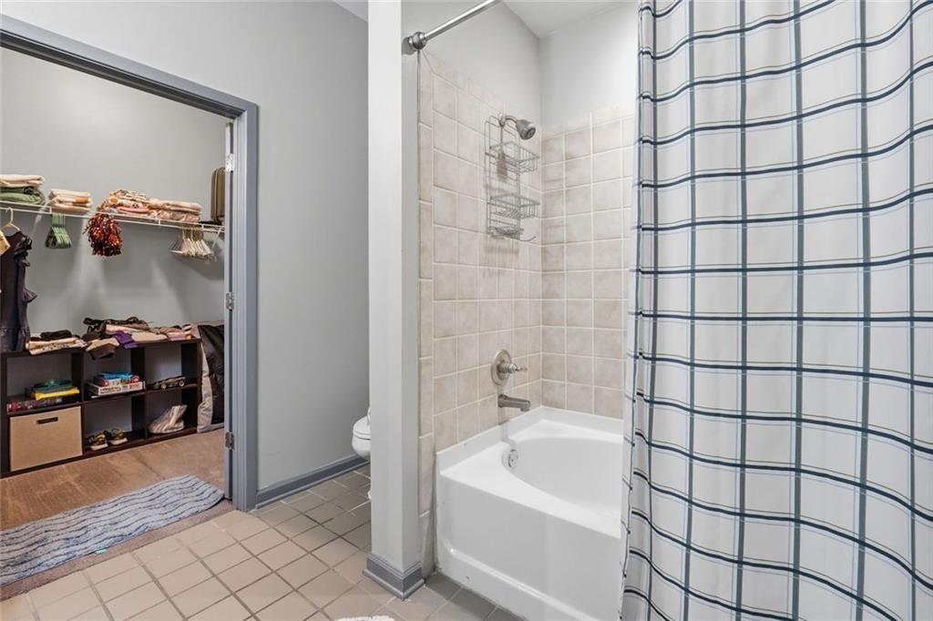5300 Peachtree Road, Unit 2604 Atlanta, GA 30341 - Photo 22 of 39 a bathroom with a bathtub and a shower