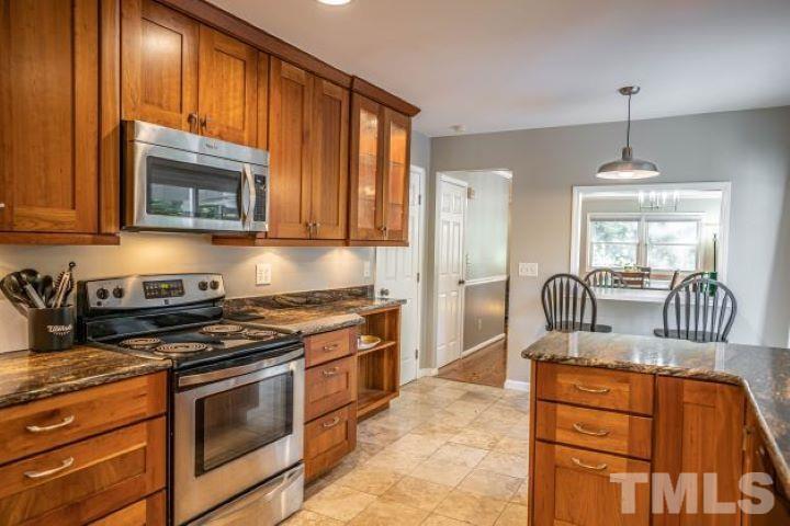 55 Rutledge Lane Pinehurst, NC 28374 - Photo 6 of 21 a kitchen with granite countertop wooden cabinets stainless steel appliances and a window