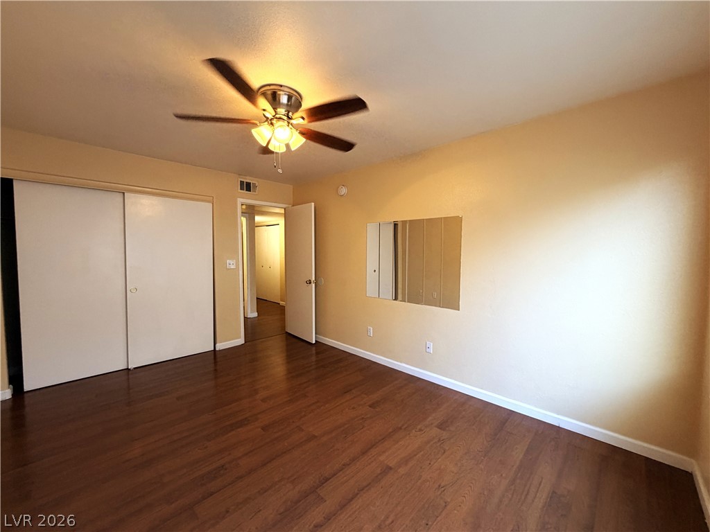 4955 South Lindell Road, Unit 203 Las Vegas, NV 89118 - Photo 13 of 31 Rich hardwood floors complement the neutral walls in this spacious sleeping quarter.
