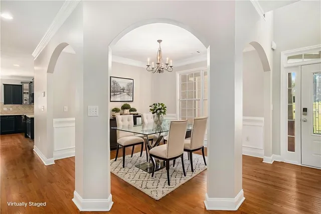a view of a dining room with furniture and wooden floor