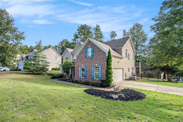 a front view of a house with a yard