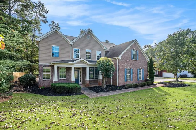 a front view of a house with a yard