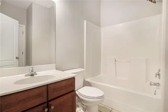 a bathroom with a sink toilet a mirror and shower