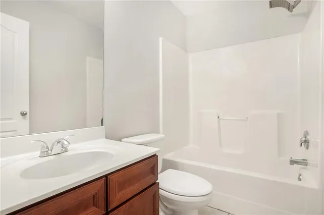 a bathroom with a sink toilet vanity and bathtub