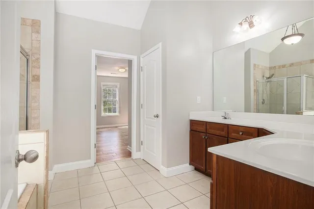 a bathroom with a sink a mirror and a shower