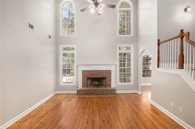 wooden floor fireplace and windows