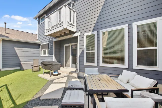 a view of a patio with table and chairs and wooden floor