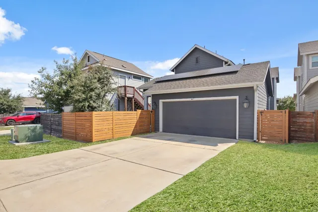 a view of a house with a yard and garage