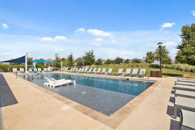 a view of swimming pool with outdoor seating and city view