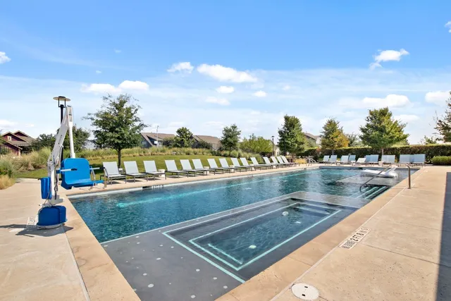 a view of swimming pool with outdoor seating and lake view