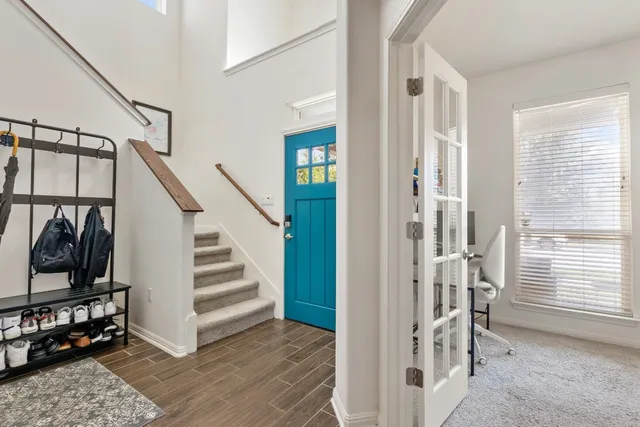 a view of a hallway with wooden floor and entryway