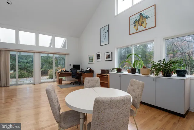 a livingroom with workspace and a window