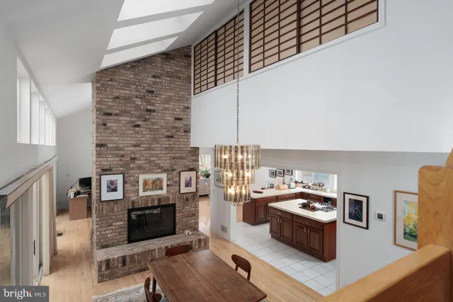 a spacious bedroom with a bed and chair