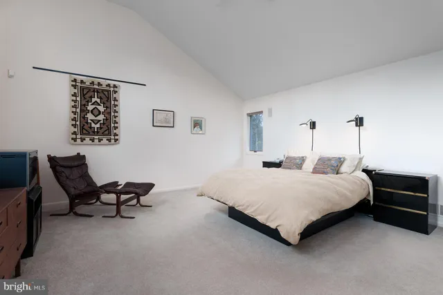 a bedroom with a bed and a couch