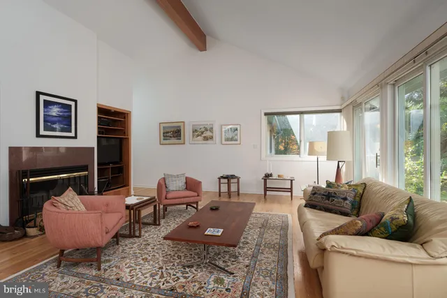 a living room with furniture rug and a fireplace