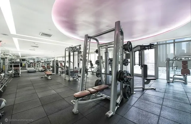 a living room with couches a coffee table and a flat screen tv with wooden floor
