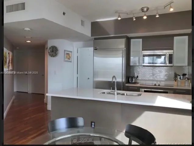 a bedroom with a bed lamp and window