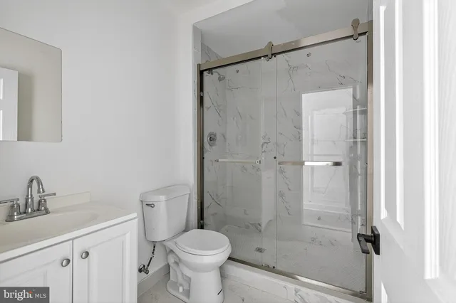 a bathroom with a shower a toilet and a sink